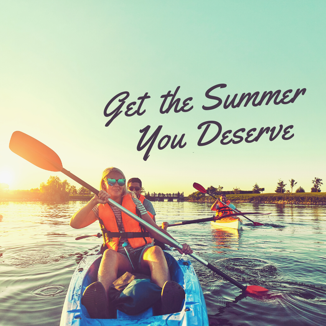Two people kayaking on a calm lake at sunset, both wearing life jackets and smiling. Text reads, Get the Summer You Deserve. Other kayakers are visible in the background.